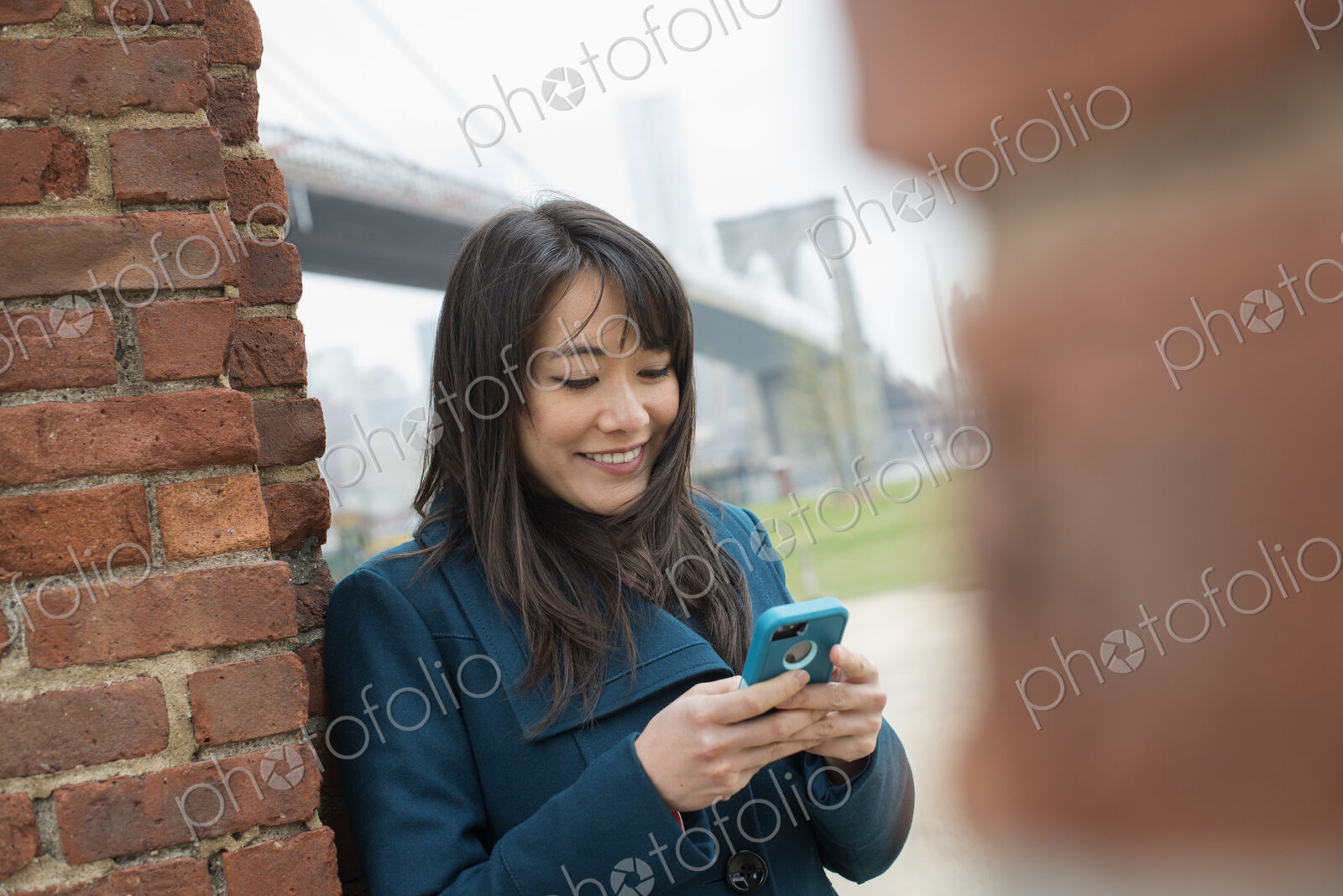 New York city. The Brooklyn Bridge crossing over the East River. A woman leaning…