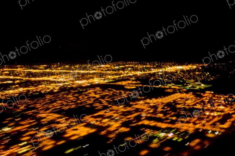 Night aerial of Illuminated urban areas, a cityscape lit up.