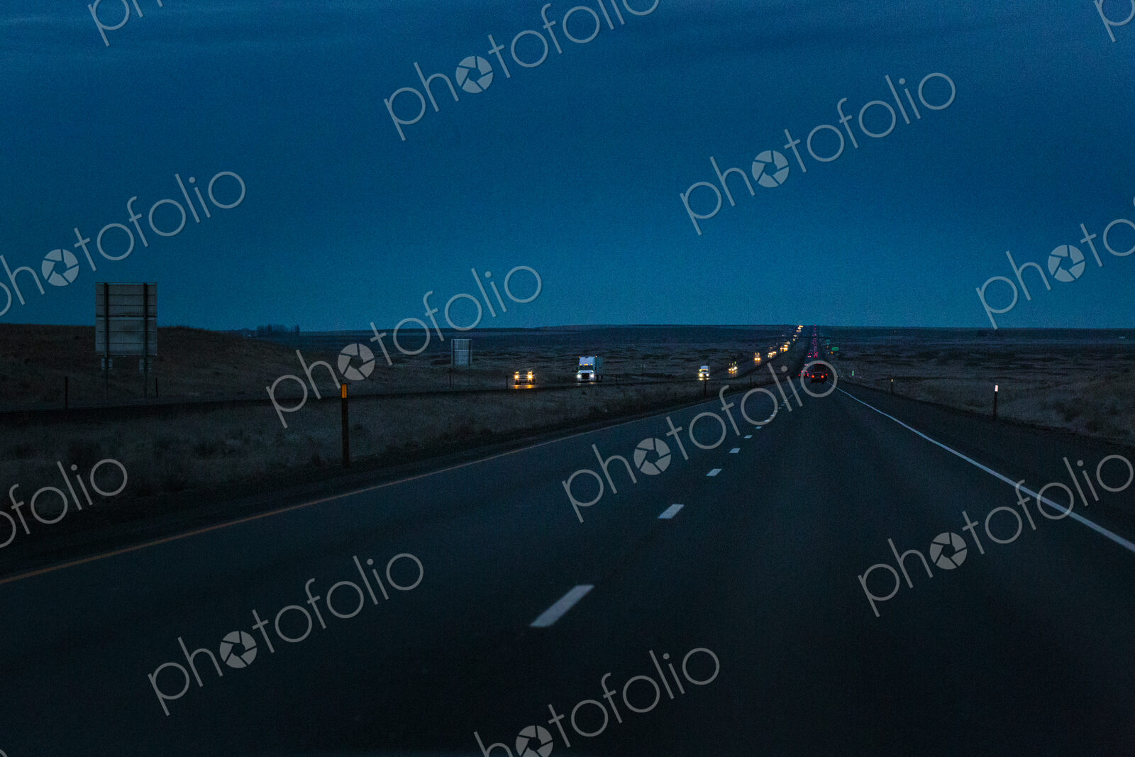 Night driving on Interstate 90, a view of the oncoming traffic.