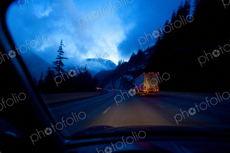 Night highway driving on Snoqualmie Pass, a moonlight sky with clouds, driver's point…