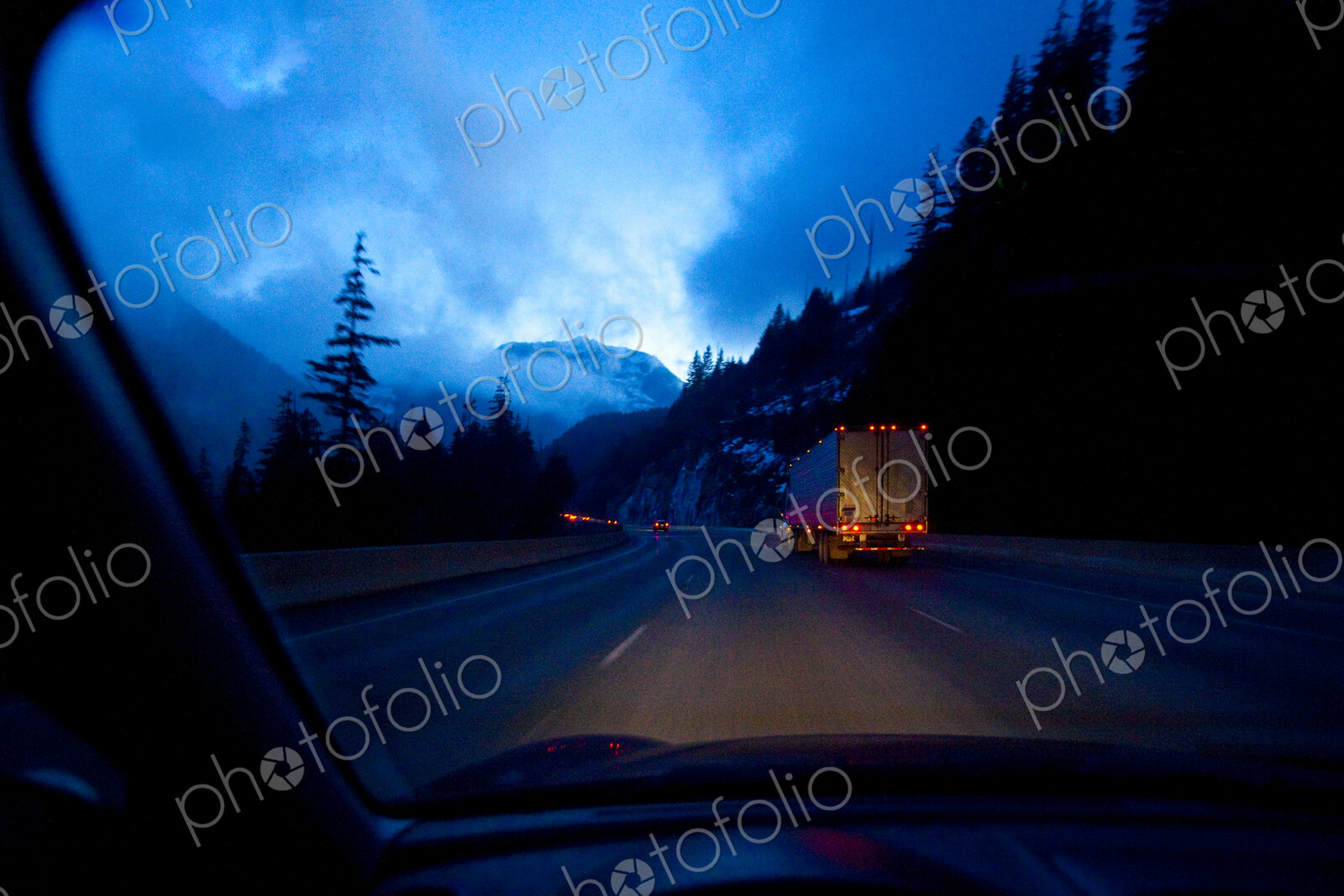 Night highway driving on Snoqualmie Pass, a moonlight sky with clouds, driver’s point…