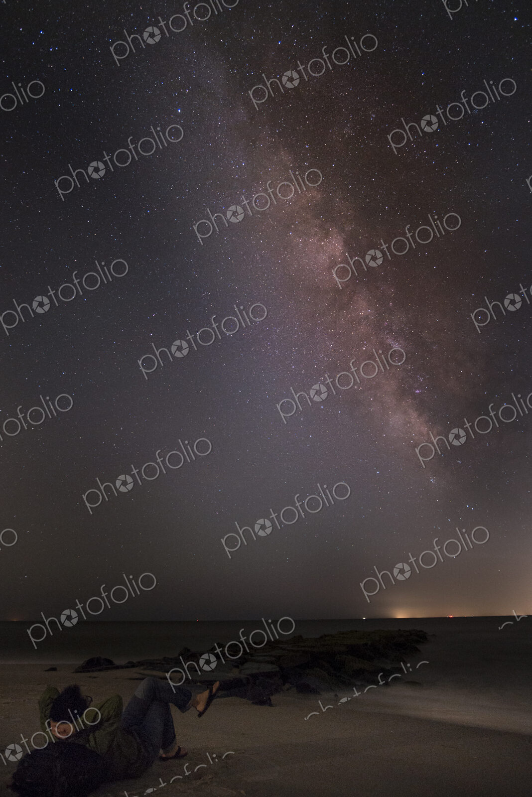 Night sky full of stars above empty flat rural landscape.
