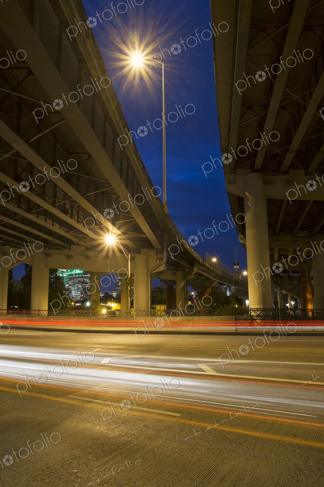 Night view of Interstate 5 freeway overpass in Portland, Oregon with glowing…