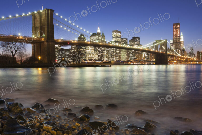 Night view towards Manhattan from Brooklyn, with the Brooklyn Bridge spanning the East…