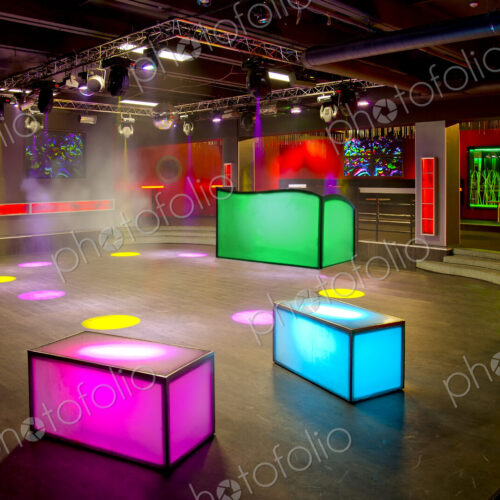 Nightclub interior, colourful lighting, wall screens and light boxes on a dance floor. Nightclub interior, colourful lighting, wall screens and light boxes on a dance floor.