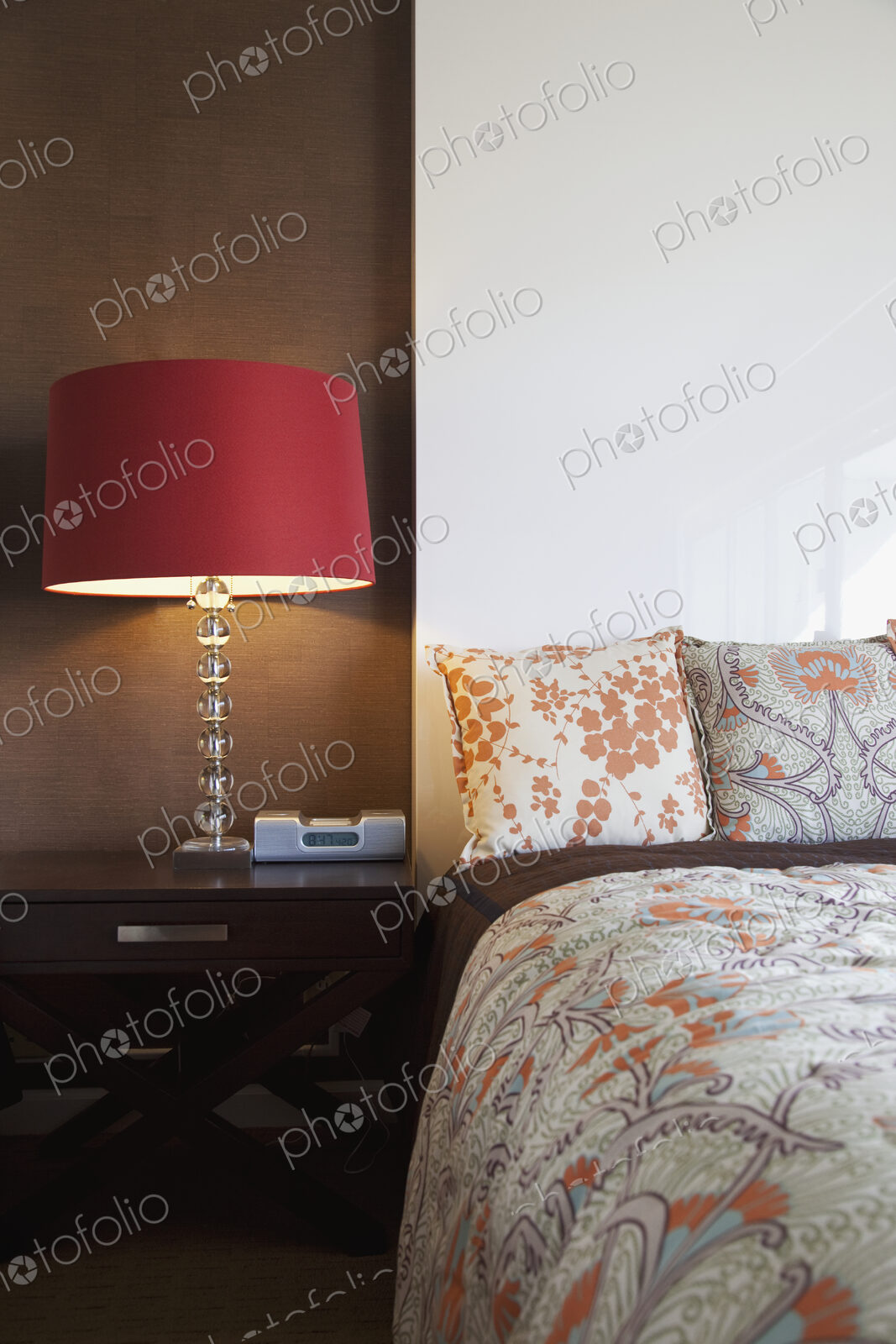 Nightstand and Lamp Next to a Bed
