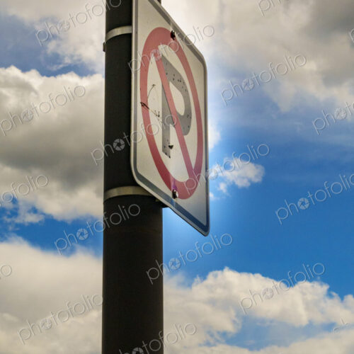 No parking sign, low angle view, clouds in the sky.