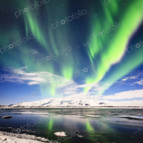 Northern lights reflecting in still remote river