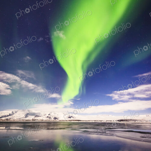Northern lights reflecting in still remote river