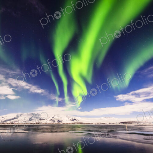 Northern lights reflecting in still remote river Northern lights reflecting in still remote river