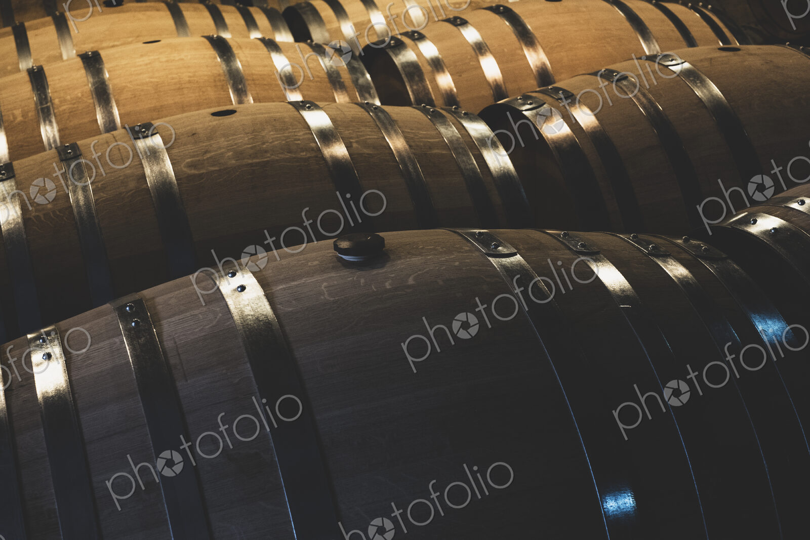 Oak wine barrels in a winery.