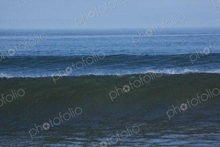 Ocean Waves reaching the shore, white water and spray.