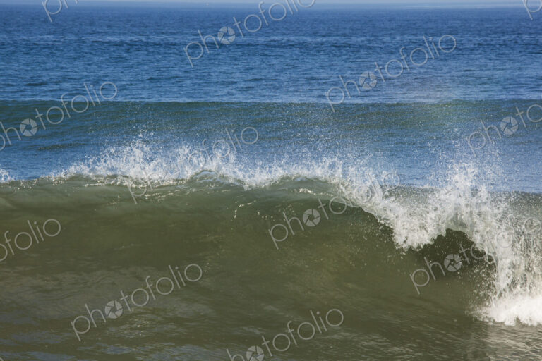 Ocean Waves reaching the shore, white water and spray.