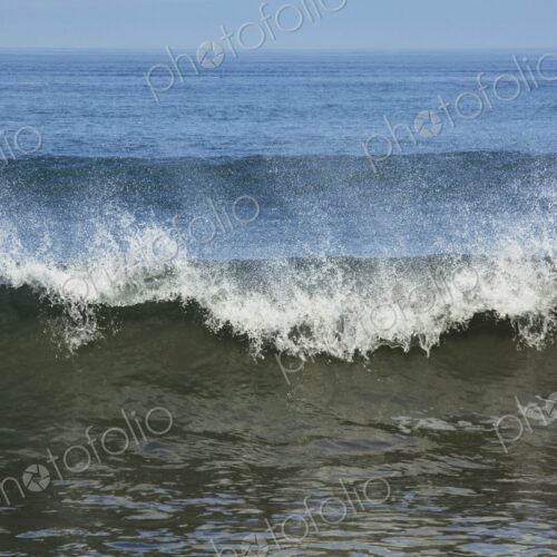 Ocean Waves reaching the shore, white water and spray.