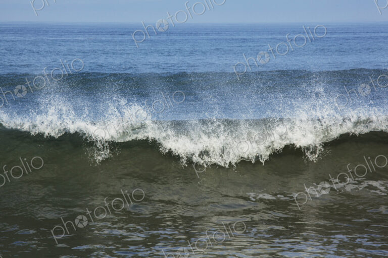 Ocean Waves reaching the shore, white water and spray.