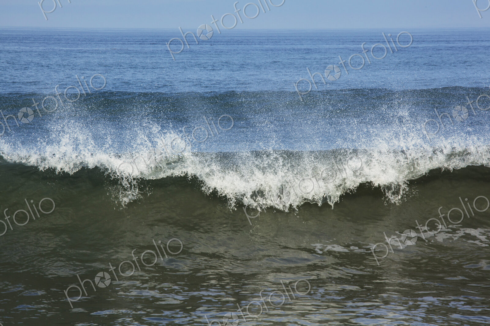 Ocean Waves reaching the shore, white water and spray.