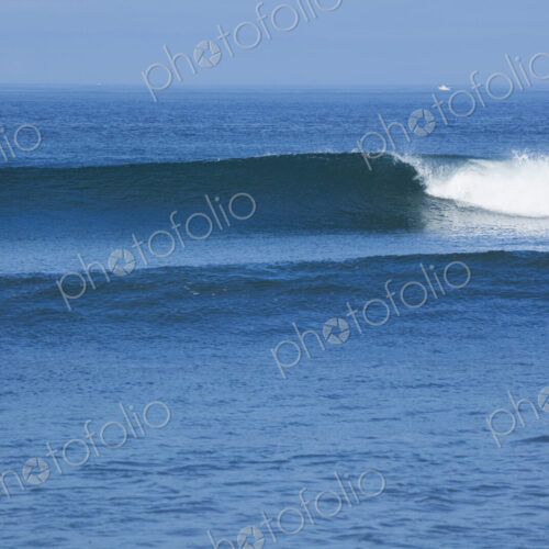 Ocean Waves rolling towards the shore, white water and spray on the breakers.