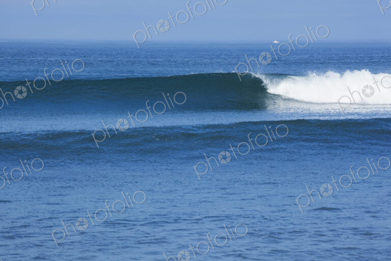 Ocean Waves rolling towards the shore, white water and spray on the breakers.