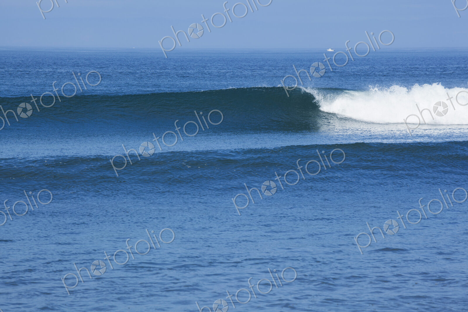 Ocean Waves rolling towards the shore, white water and spray on the breakers.