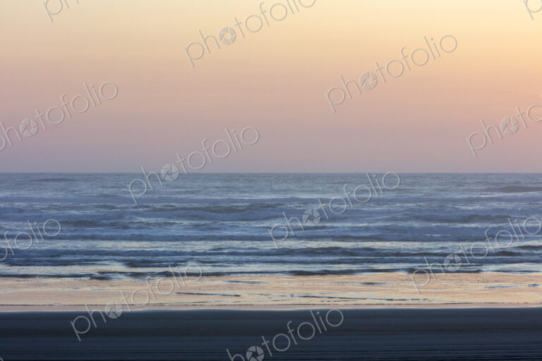Ocean waves and beach at sunset