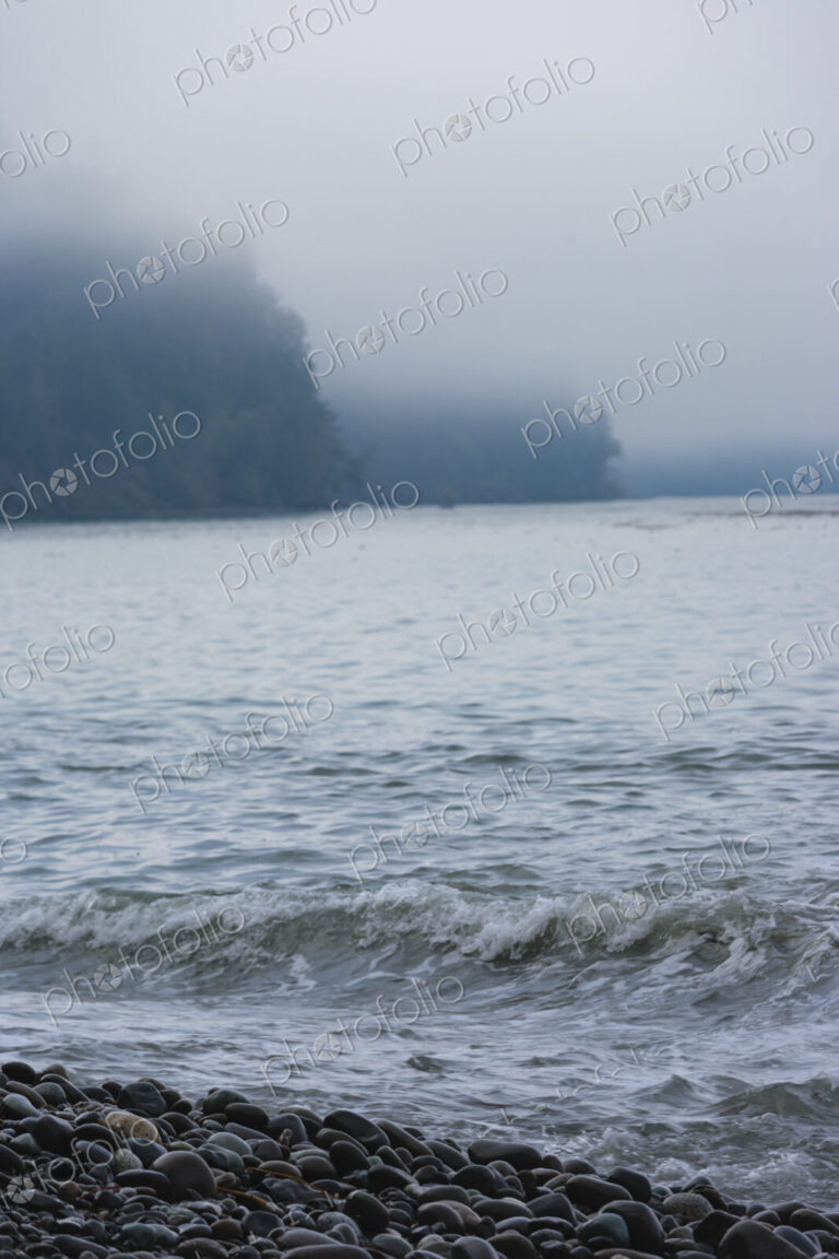 Ocean waves breaking on a beach of smooth rocks, Strait of Juan de Fuca, Port Angeles