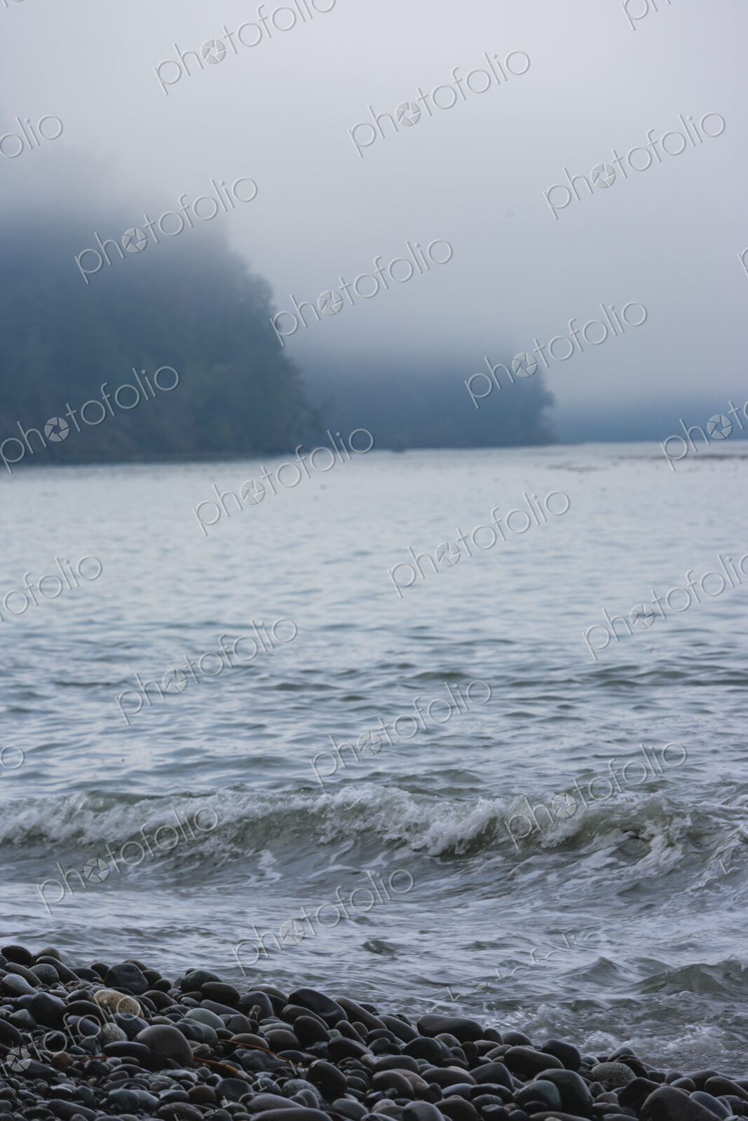 Ocean waves breaking on a beach of smooth rocks, Strait of Juan de Fuca, Port Angeles