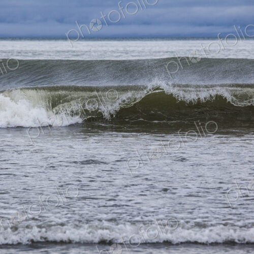 Ocean waves breaking on a beach, view out to the ocean. Ocean waves breaking on a beach, view out to the ocean.