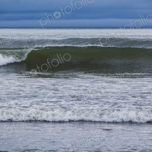 Ocean waves breaking on a beach, view out to the ocean.