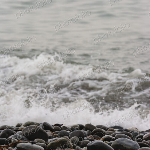 Ocean waves breaking on the shore of smooth beach pebbles, Strait of Juan de Fuca.