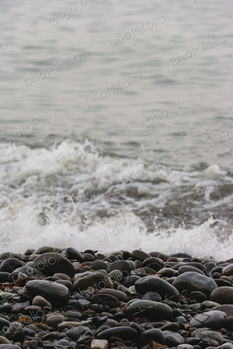 Ocean waves breaking on the shore of smooth beach pebbles, Strait of Juan de Fuca.