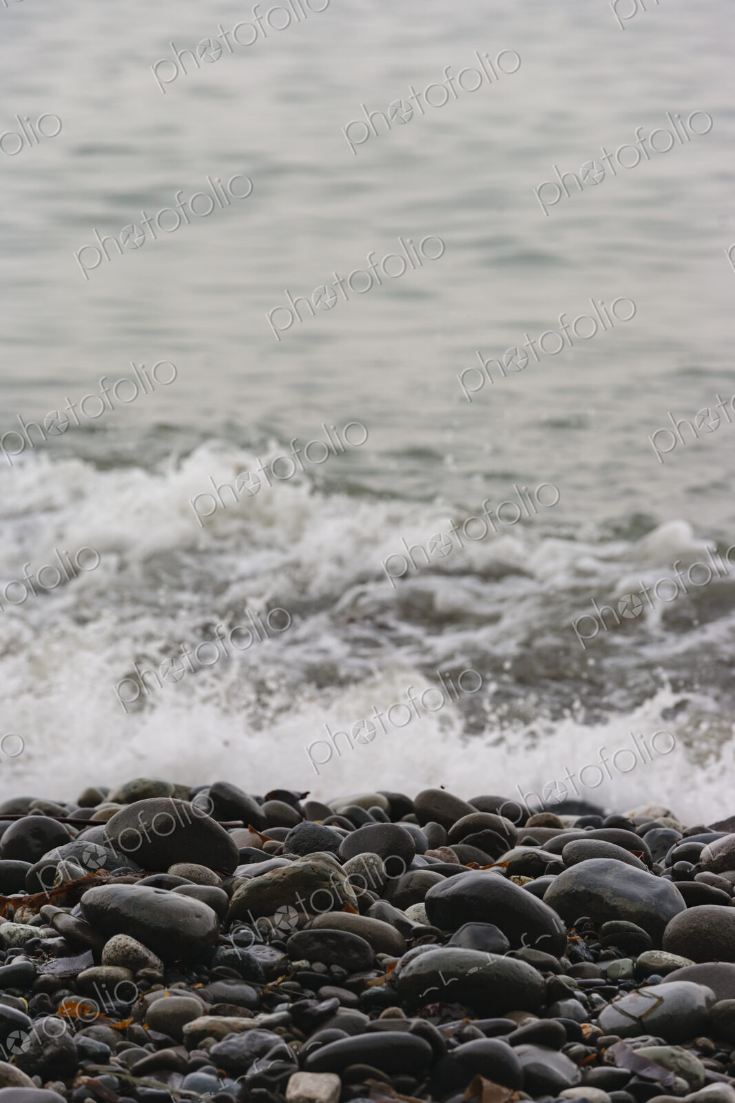 Ocean waves breaking on the shore of smooth beach pebbles, Strait of Juan de Fuca.