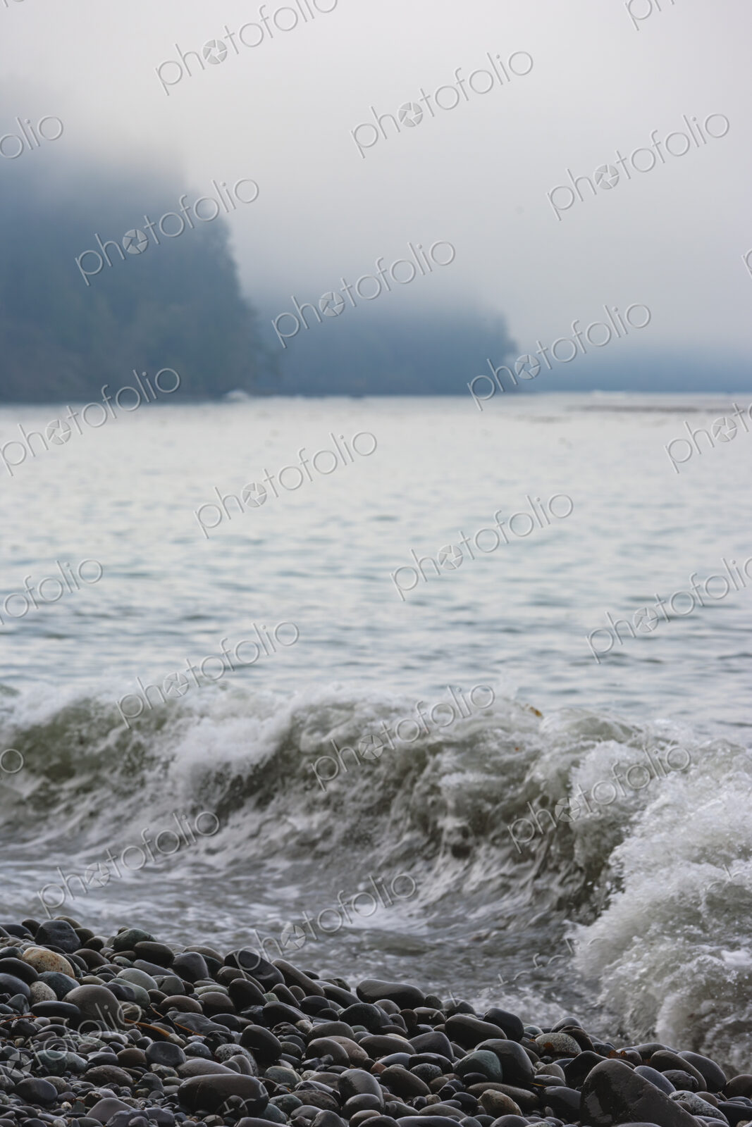 Ocean waves breaking over smooth beach pebbles, Strait of Juan de Fuca