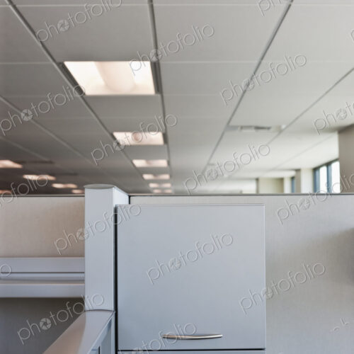 Office cubicle with filing cabinet.