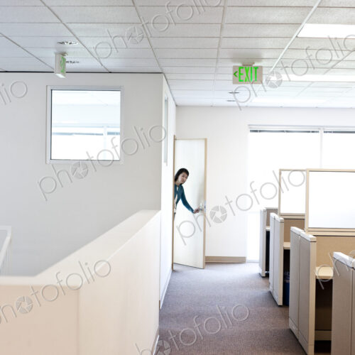Office worker coming into cubicle work area of new office. Office worker coming into cubicle work area of new office.