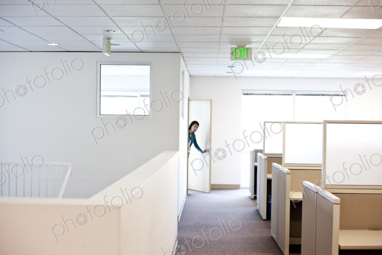 Office worker coming into cubicle work area of new office.