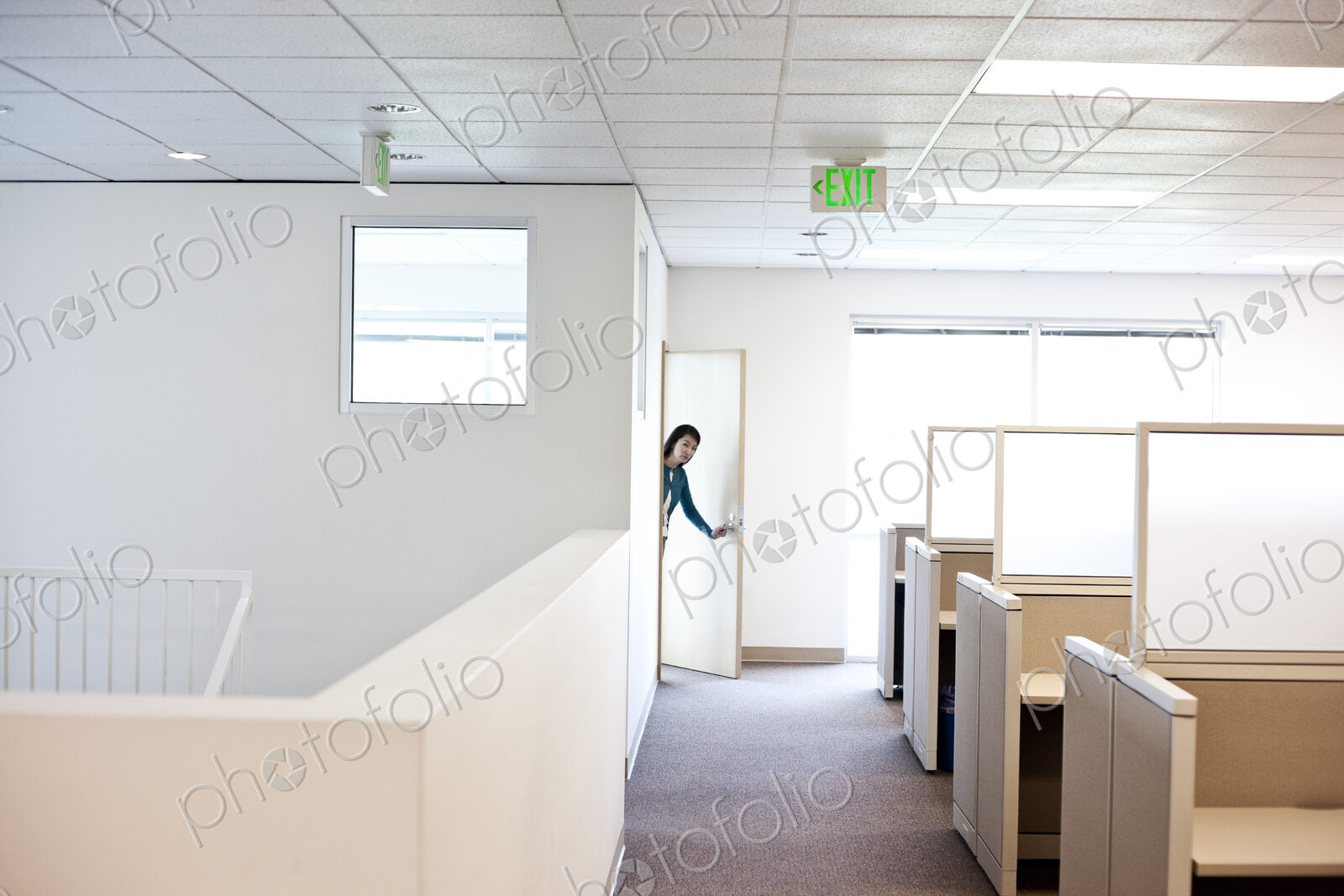 Office worker coming into cubicle work area of new office.