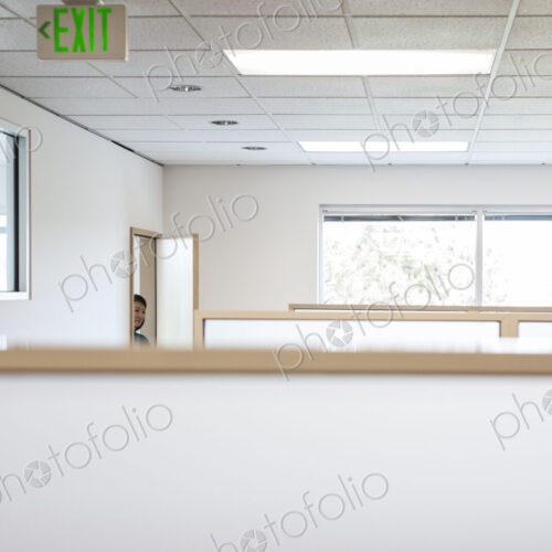 Office worker coming into cubicle work area of new office. Office worker coming into cubicle work area of new office.