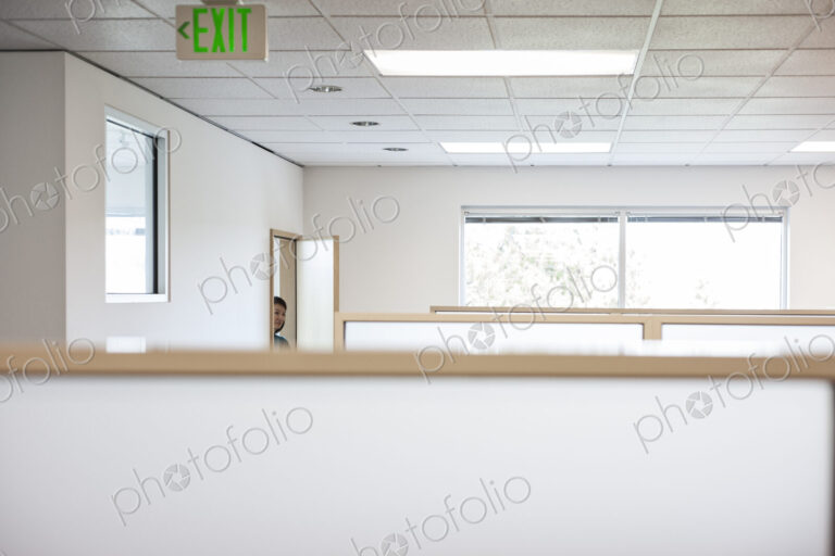 Office worker coming into cubicle work area of new office.