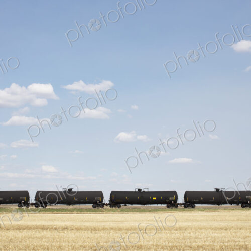 Oil train cars and fallow farmland, near Swift Current, Saskatchewan, Canada. Oil train cars and fallow farmland, near Swift Current, Saskatchewan, Canada.
