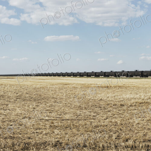 Oil train cars and fallow farmland, near Swift Current, Saskatchewan, Canada. Oil train cars and fallow farmland, near Swift Current, Saskatchewan, Canada.
