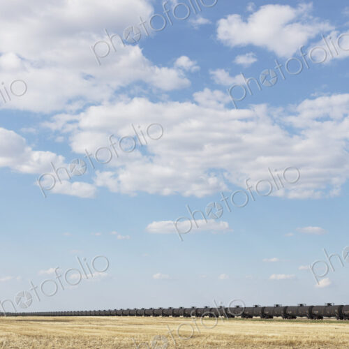 Oil train cars and fallow farmland, near Swift Current, Saskatchewan, Canada. Oil train cars and fallow farmland, near Swift Current, Saskatchewan, Canada.