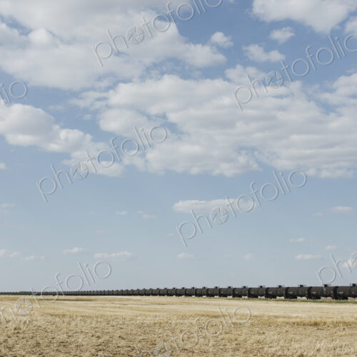 Oil train cars and fallow farmland, near Swift Current, Saskatchewan, Canada. Oil train cars and fallow farmland, near Swift Current, Saskatchewan, Canada.