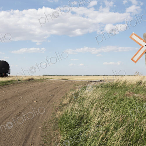 Oil train cars and road crossing, near Swift Current, Saskatchewan, Canada. Oil train cars and road crossing, near Swift Current, Saskatchewan, Canada.