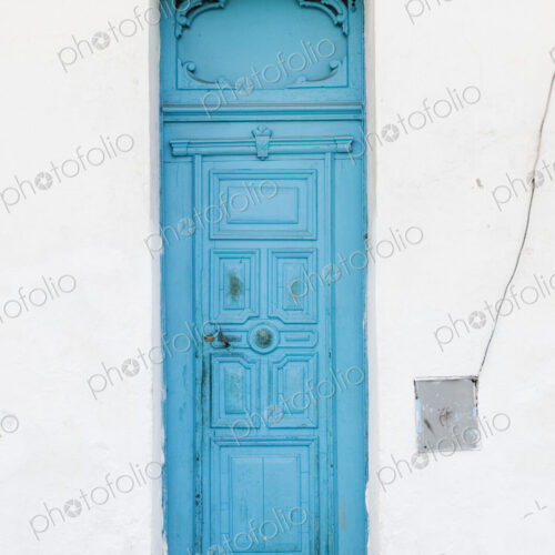 Old Blue Door on White Wall Old Blue Door on White Wall