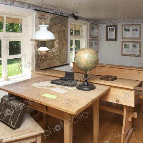 Old Fashioned Classroom in a school house, desks and oil lamps