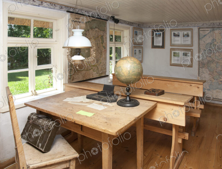 Old Fashioned Classroom in a school house, desks and oil lamps