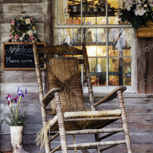 Old Wooden Rocking Chair on a Wooden Porch