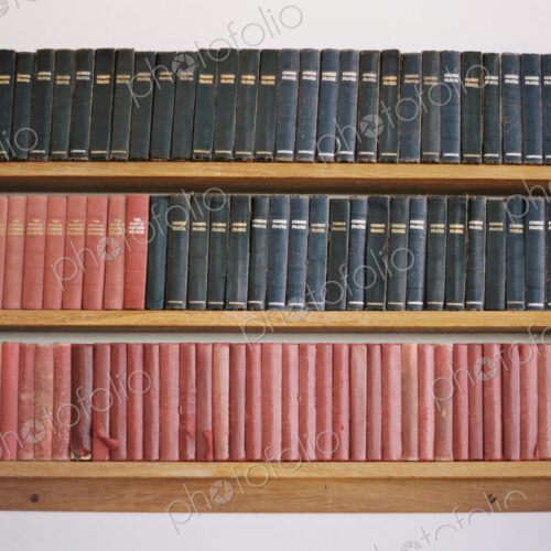 Old books on a shelf. Traditional church prayer books. Worn covers. Old books on a shelf. Traditional church prayer books. Worn covers.