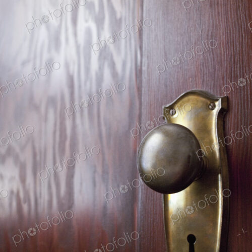 Old-fashioned Doorknob on a Wooden Door