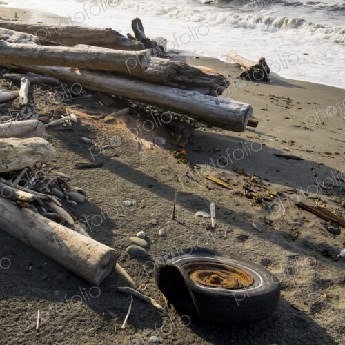 Old tire on wilderness beach, Freshwater Bay, Port Angeles.